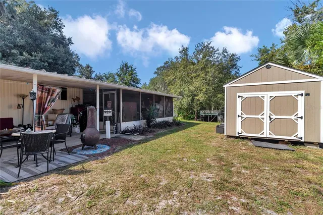 a view of a house with backyard porch and sitting area