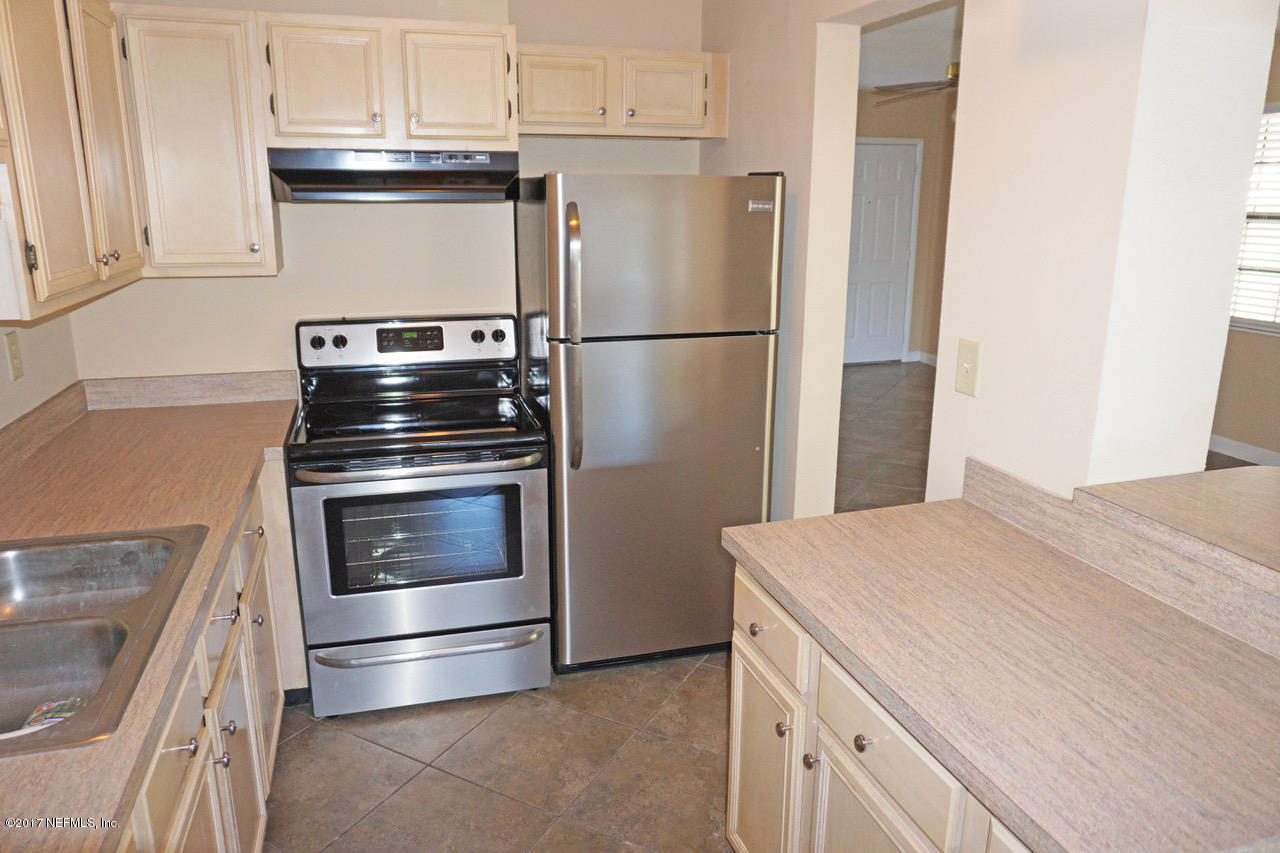 6141 Stetson Road Jacksonville, FL 32217 - Photo 8 of 16 a kitchen with a refrigerator stove and cabinets