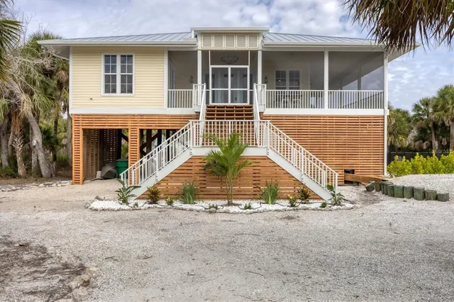 a view of backyard of house and tree