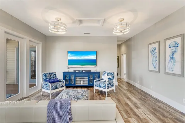 a living room with furniture a chandelier and a window