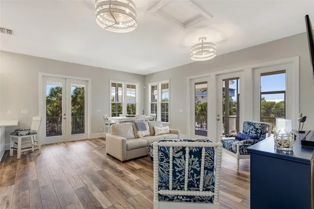 a living room with furniture a fireplace and wooden floor