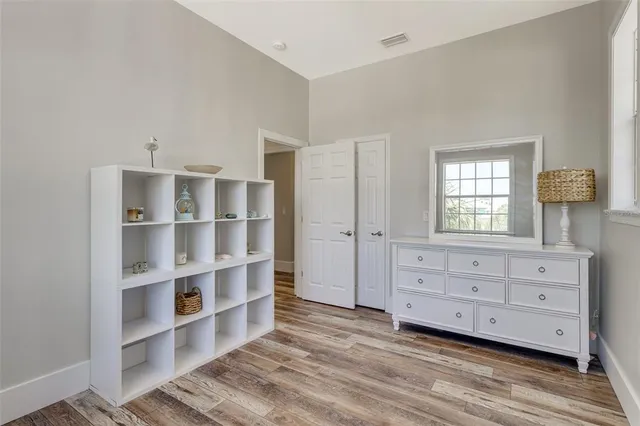 a view of wooden floor and windows in a room