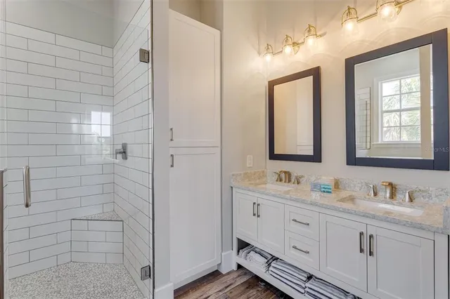 a bathroom with a double vanity sink mirror and double