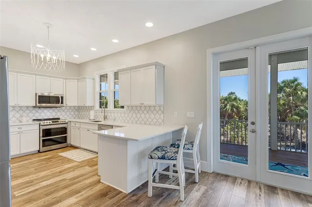 a kitchen with granite countertop a sink stove and refrigerator