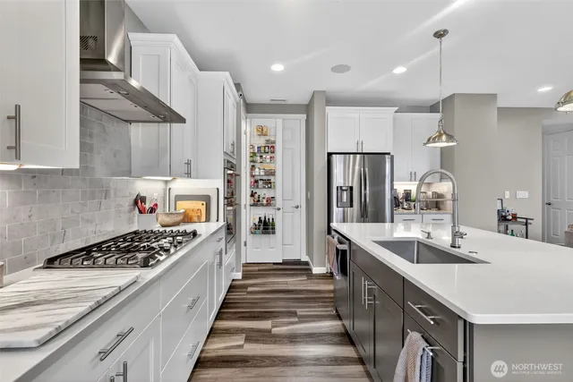a kitchen with stainless steel appliances a sink stove and refrigerator