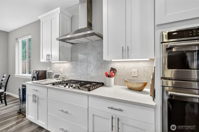 a kitchen with stainless steel appliances granite countertop a stove and a refrigerator
