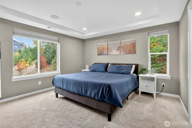 a spacious bedroom with a large bed and a large window