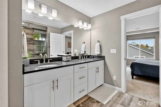 a en suite bathroom with double sink and a mirror