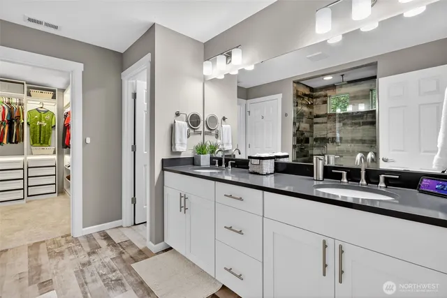a bathroom with a double vanity sink and a mirror