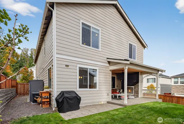 a view of a house with a yard and sitting area