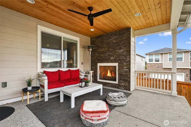 a outdoor space with patio couch and a fireplace