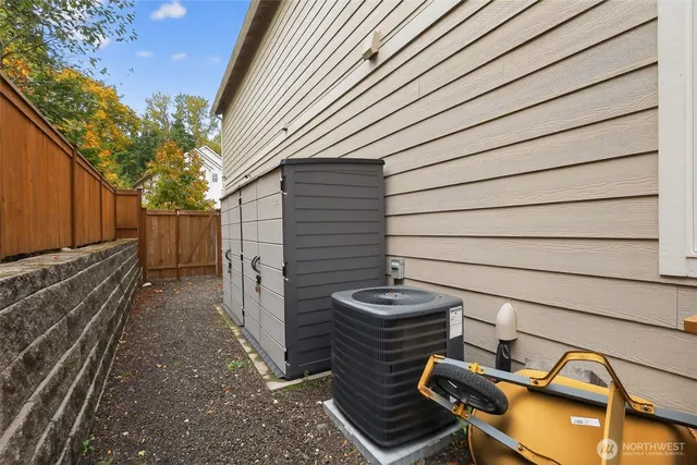a view of a backyard with chairs and wooden fence
