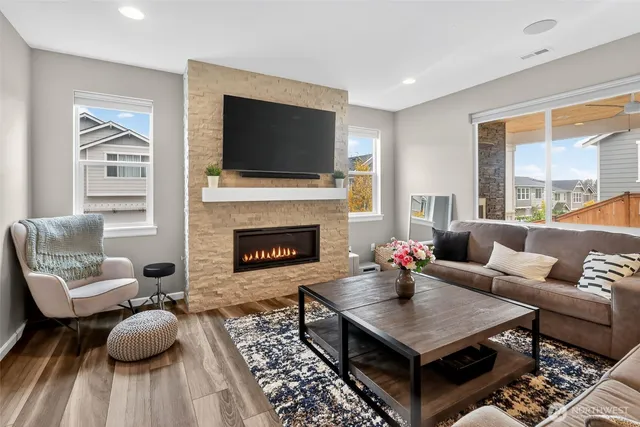 a living room with furniture a flat screen tv and a fireplace