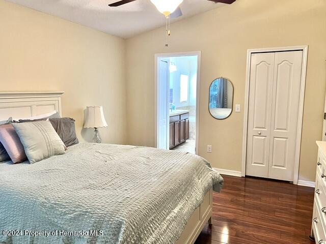 18430 Waydale Loop Hudson, FL 34667 - Photo 19 of 30 a bedroom with a bed and wooden floor