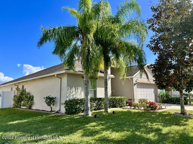 18430 Waydale Loop Hudson, FL 34667 - Photo 2 of 30 a front view of house with yard and green space