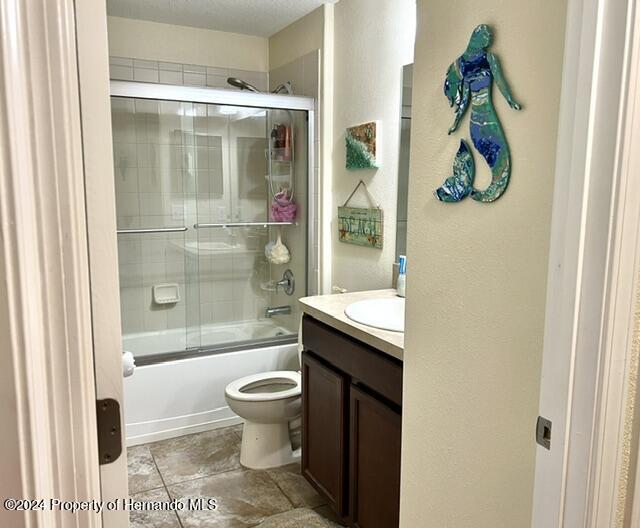 18430 Waydale Loop Hudson, FL 34667 - Photo 21 of 30 a bathroom with a granite countertop shower a toilet and a sink