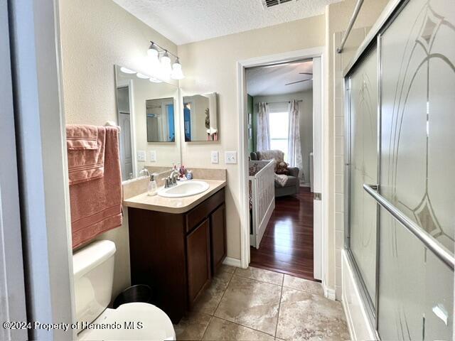 18430 Waydale Loop Hudson, FL 34667 - Photo 22 of 30 a bathroom with a sink a toilet and mirror
