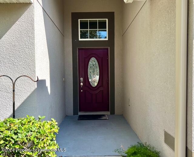 18430 Waydale Loop Hudson, FL 34667 - Photo 3 of 30 a front view of a house with entryway