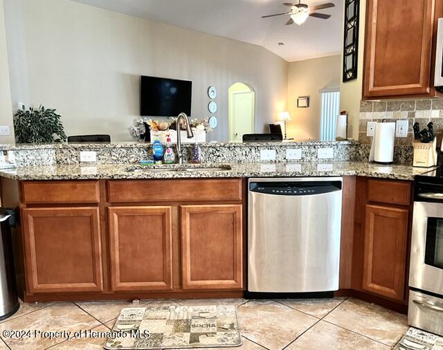 18430 Waydale Loop Hudson, FL 34667 - Photo 7 of 30 a kitchen with stainless steel appliances granite countertop a sink and a stove top oven