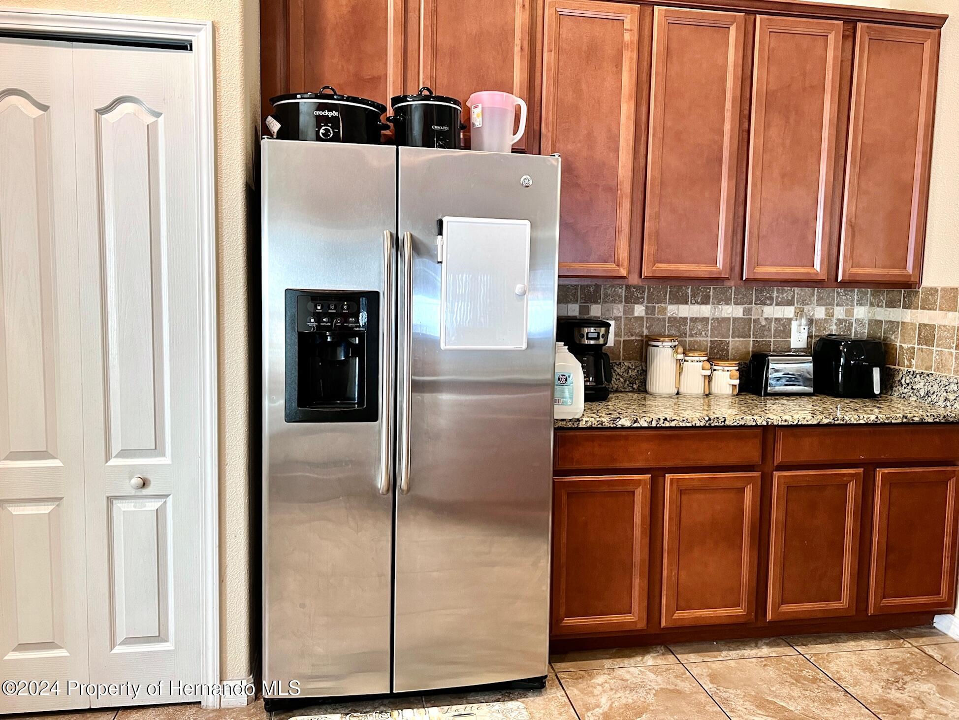 18430 Waydale Loop Hudson, FL 34667 - Photo 9 of 30 a kitchen with stainless steel appliances granite countertop a refrigerator and a sink