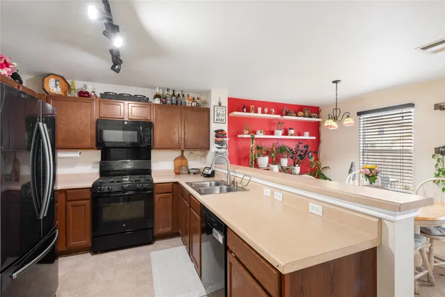 a kitchen with a sink stove and refrigerator