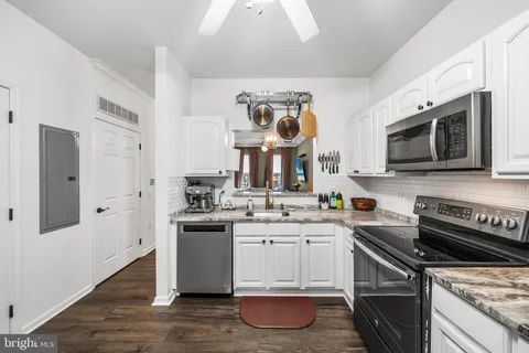 a kitchen with stainless steel appliances a sink stove and microwave