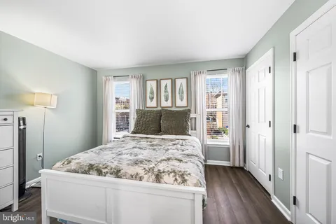 a bedroom with a large bed and a dresser