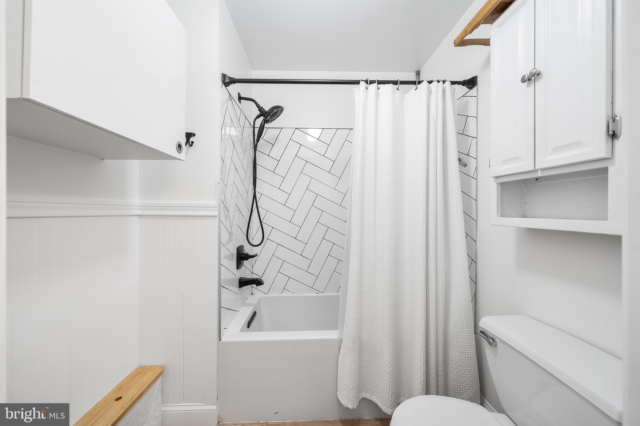 768 South 13th Street Philadelphia, PA 19147 - Photo 19 of 31 a bathroom with a shower curtain a sink and a toilet