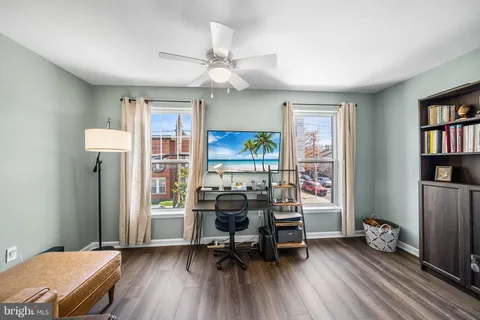 a view of a livingroom with furniture window and wooden floor