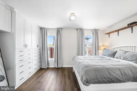 a bedroom with a large bed and a window