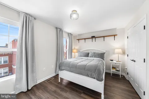 a bedroom with a bed and a window
