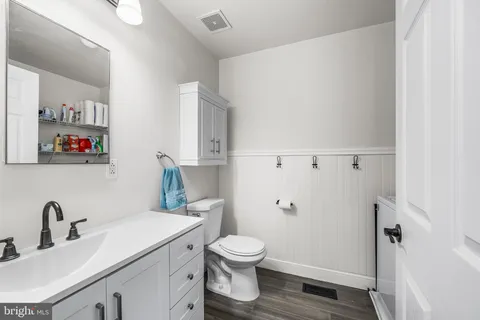a bathroom with a toilet a sink and a mirror