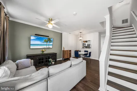 a living room with furniture and a chandelier