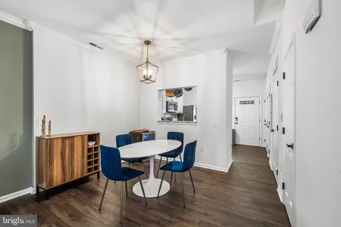 a view of a dining room with furniture wooden floor and a chandelier
