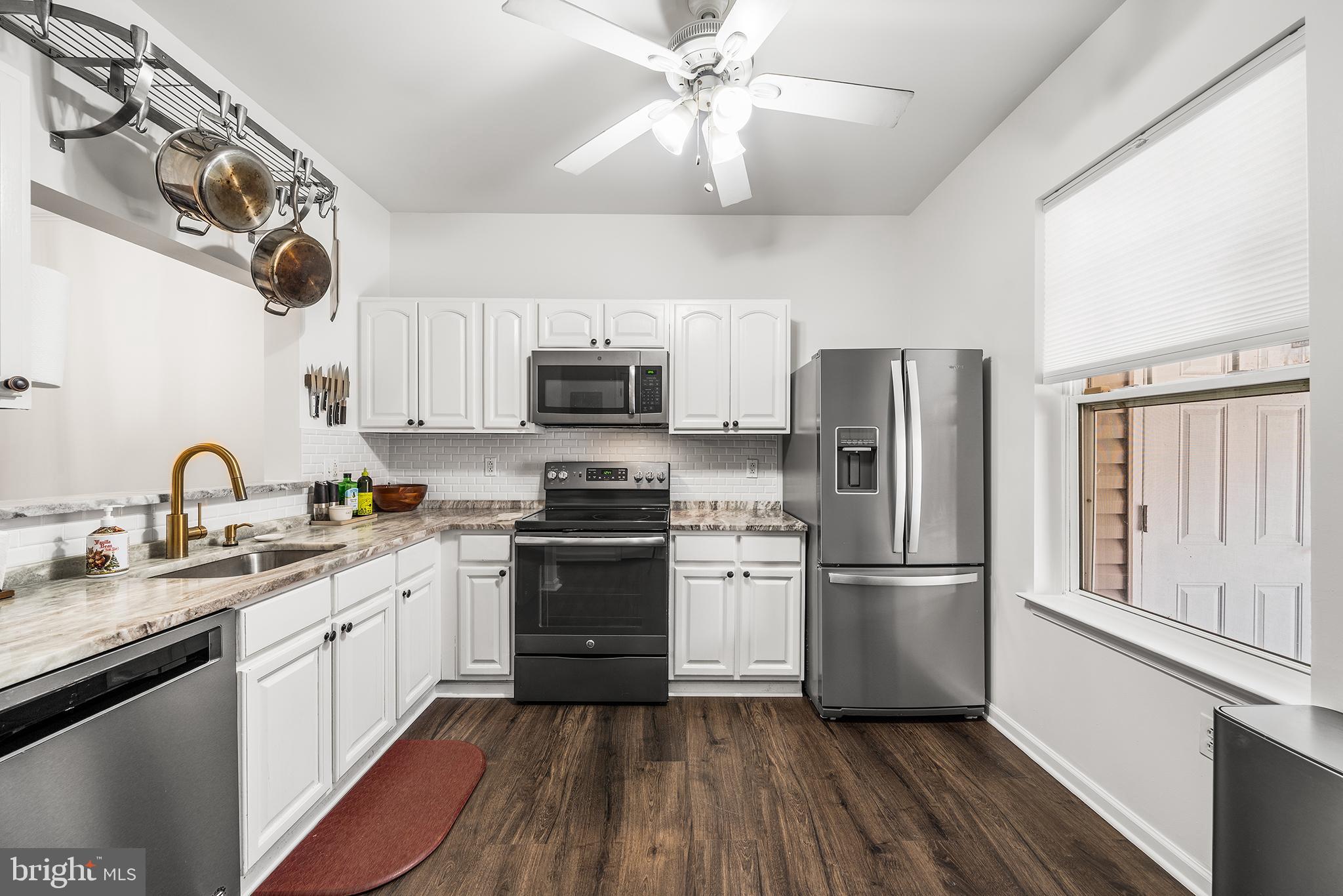 768 South 13th Street Philadelphia, PA 19147 - Photo 10 of 31 a kitchen with stainless steel appliances a refrigerator a stove sink microwave and cabinets