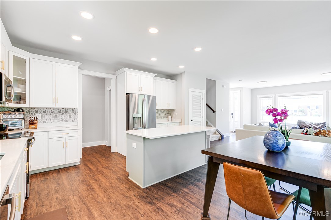 509 Danray Drive Richmond, VA 23227 - Photo 13 of 37 a kitchen with granite countertop a dining table chairs and white cabinets
