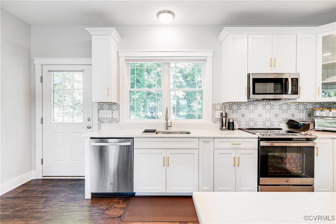 509 Danray Drive Richmond, VA 23227 - Photo 6 of 37 a kitchen with stainless steel appliances a stove sink microwave and window