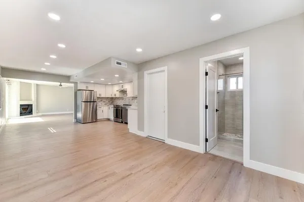 a kitchen with stainless steel appliances a refrigerator sink and cabinets