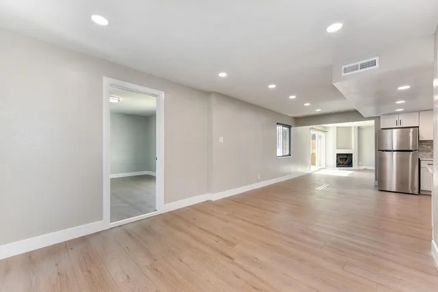 a large kitchen with a lot of counter space stainless steel appliances and cabinets