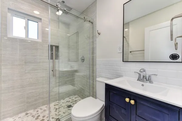 a kitchen with stainless steel appliances white cabinets and a sink