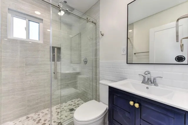 a kitchen with stainless steel appliances white cabinets and a sink
