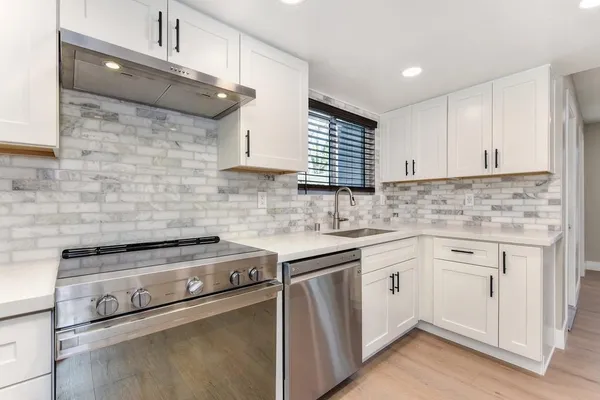 a view of kitchen with granite countertop cabinets and wooden floor