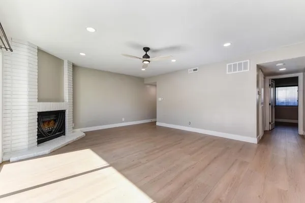 a bathroom with a bathtub shower sink vanity mirror and toilet