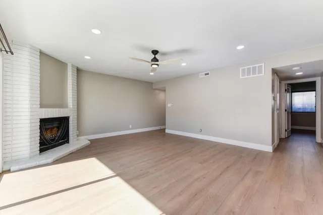 a bathroom with a bathtub shower sink vanity mirror and toilet