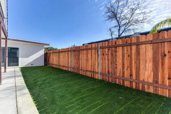 a backyard of a house with table and chairs