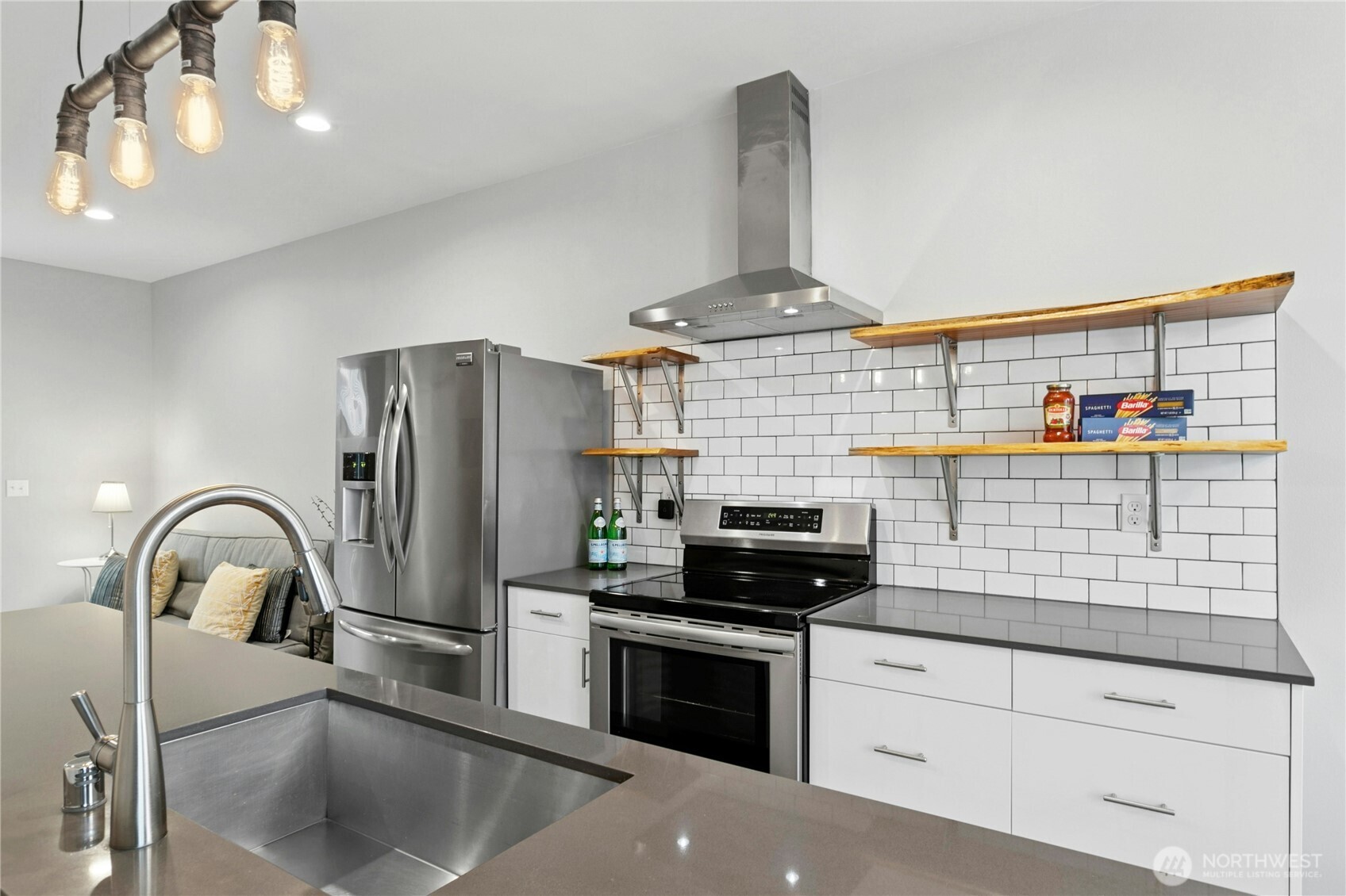 6641 Carleton Avenue South, Unit B Seattle, WA 98108 - Photo 7 of 33 a kitchen with stainless steel appliances granite countertop a sink and a stove