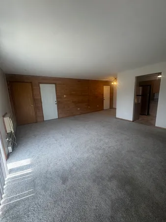 a view of an empty room with a fireplace