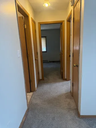 an empty room with mirror in front of it