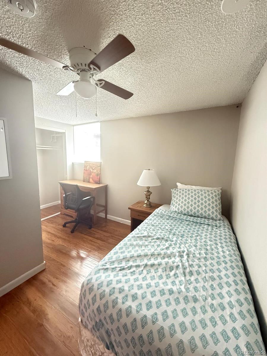 326 South Alcott Street Denver, CO 80219 - Photo 11 of 21 a bedroom with a bed and wooden floor