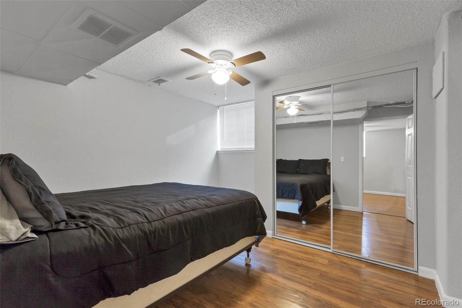 326 South Alcott Street Denver, CO 80219 - Photo 15 of 21 a bedroom with a bed and a chandelier